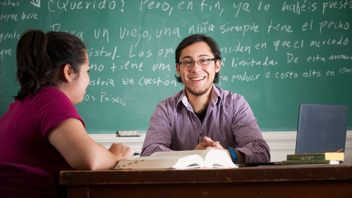 Two students studying Spanish texts.