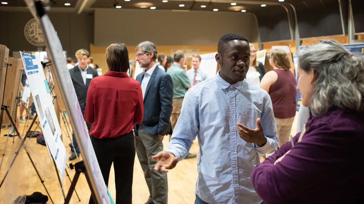 Visitors view exhibits during a symposium held in the International Ballroom