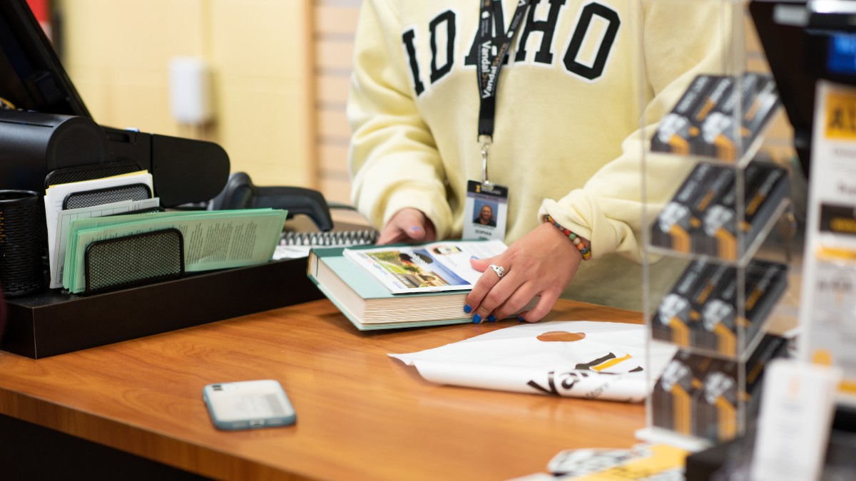 Student working the register at the VandalStore